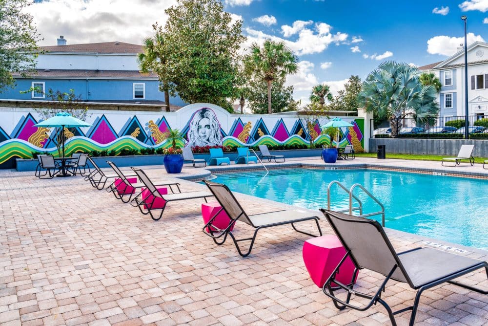 arden villas off campus apartments near the university of central florida ucf orlando resort style pool wall mural and lounge seating